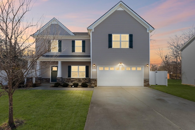 view of front of house with a garage, driveway, stone siding, and a front yard