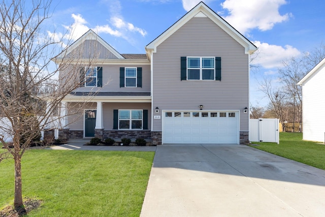 view of front of property with concrete driveway, stone siding, an attached garage, fence, and a front lawn