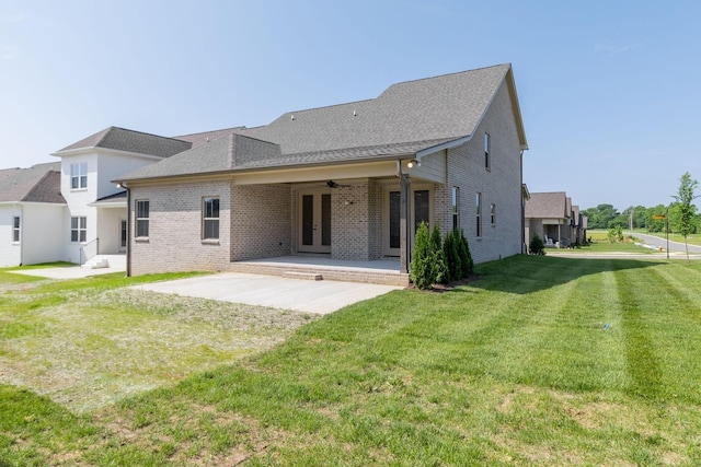 rear view of house with a patio, brick siding, a ceiling fan, a yard, and french doors