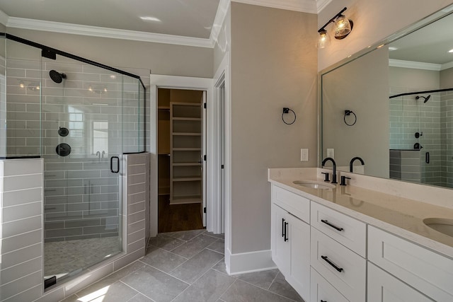 full bathroom with a sink, a spacious closet, double vanity, a stall shower, and crown molding