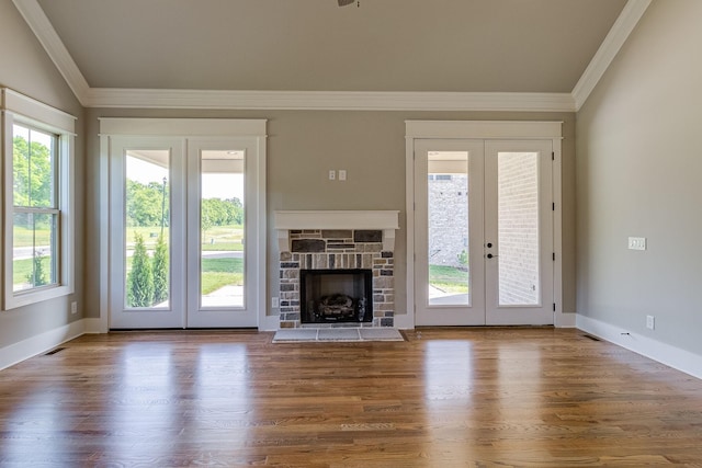 unfurnished living room featuring wood finished floors, crown molding, and french doors