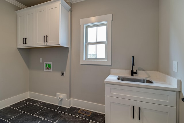 laundry area featuring hookup for a washing machine, hookup for an electric dryer, a sink, visible vents, and cabinet space