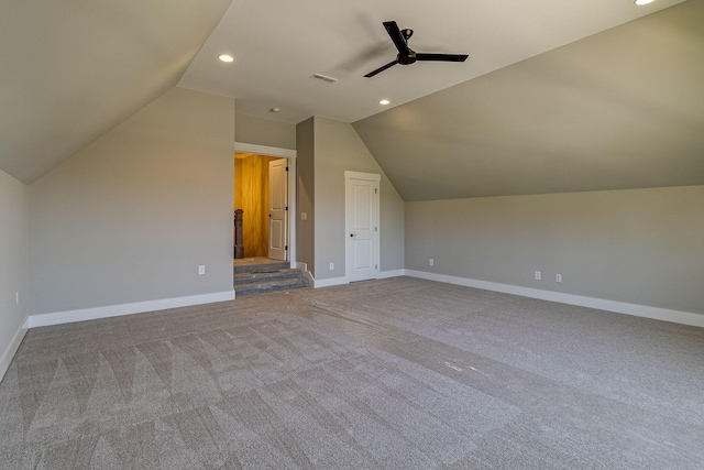 additional living space featuring lofted ceiling, recessed lighting, a ceiling fan, visible vents, and baseboards