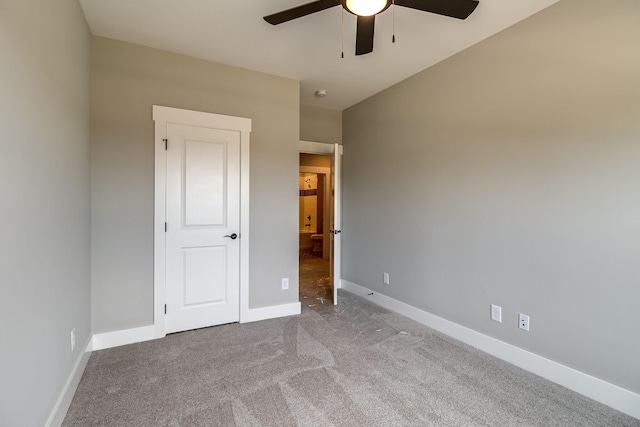 unfurnished bedroom with a ceiling fan, carpet flooring, and baseboards