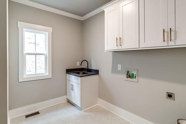 clothes washing area with cabinet space, visible vents, baseboards, a sink, and electric dryer hookup