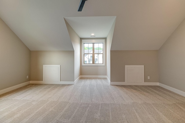 additional living space featuring vaulted ceiling, carpet floors, and baseboards