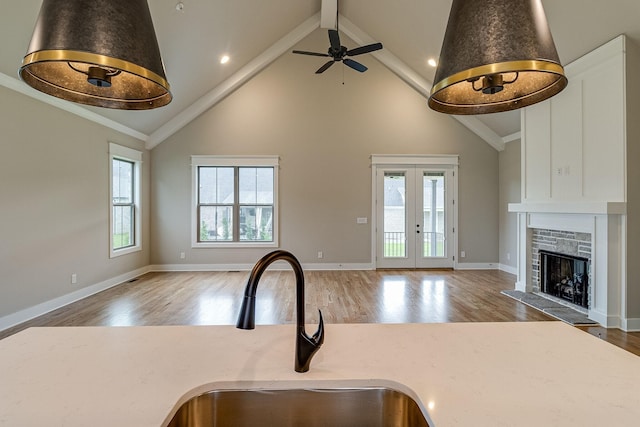 kitchen featuring open floor plan, a fireplace, and a sink