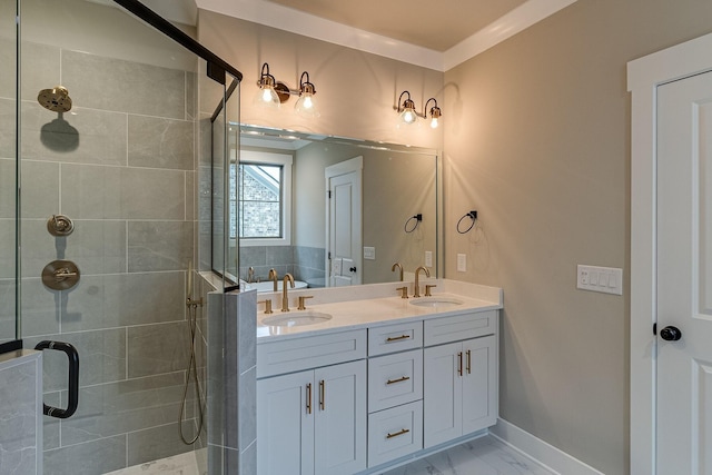 full bath with marble finish floor, double vanity, a sink, and a shower stall