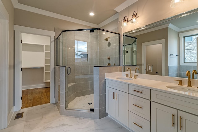 bathroom with marble finish floor, a sink, visible vents, and a shower stall