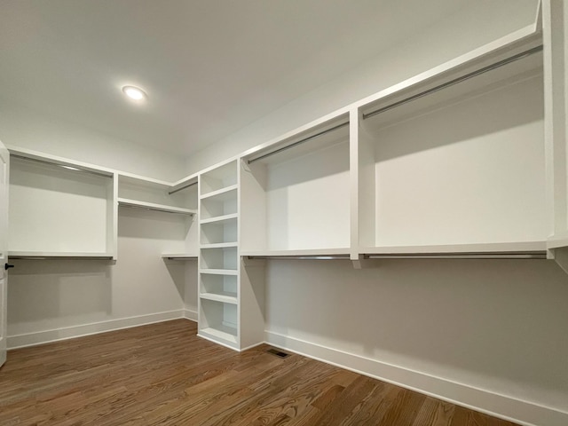 walk in closet with dark wood-type flooring and visible vents