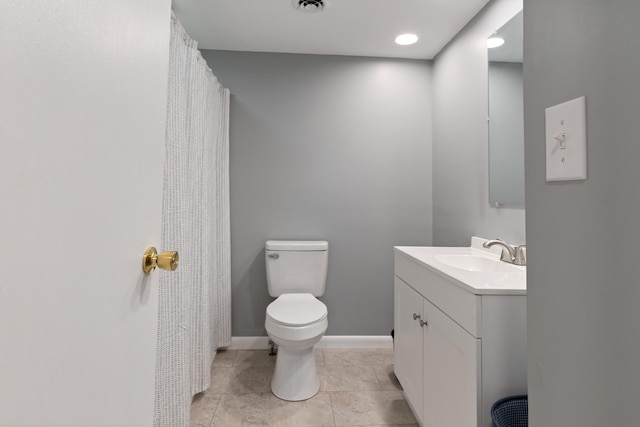 bathroom with visible vents, toilet, vanity, tile patterned flooring, and baseboards