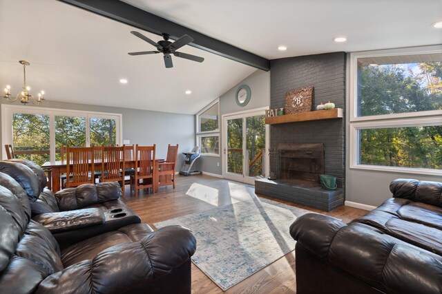 living room with baseboards, lofted ceiling with beams, wood finished floors, a fireplace, and recessed lighting