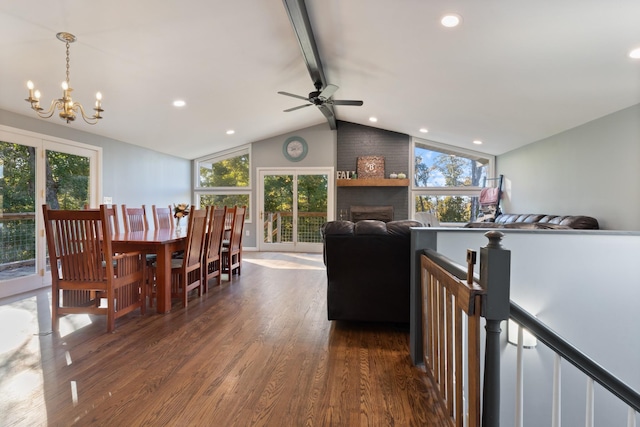 dining area with vaulted ceiling with beams, dark wood finished floors, a wealth of natural light, and a chandelier