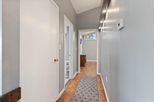 hallway with light wood-style floors and baseboards