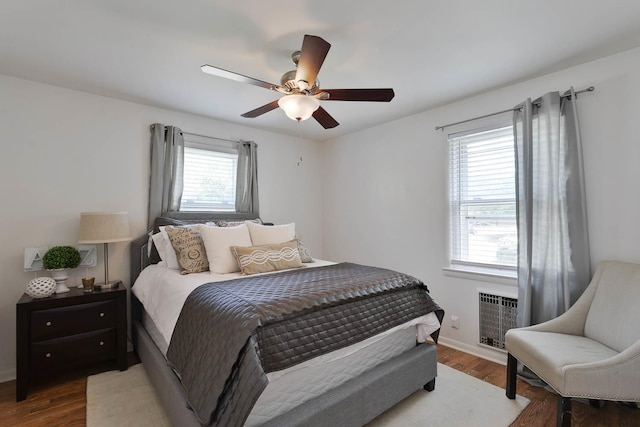 bedroom with wood finished floors, a ceiling fan, and baseboards