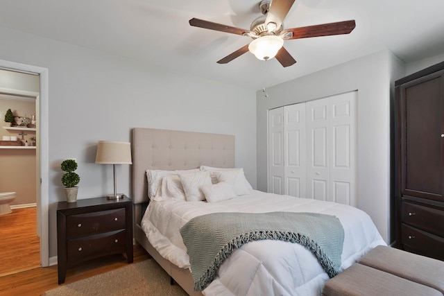 bedroom with a closet, wood finished floors, and a ceiling fan