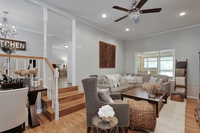 living room featuring light wood-type flooring, crown molding, and stairs