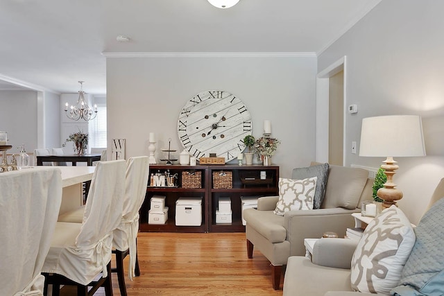 interior space with ornamental molding, light wood finished floors, and an inviting chandelier