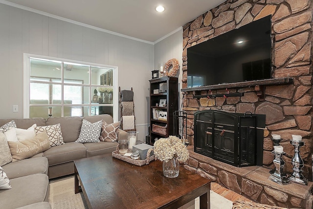 living area with ornamental molding and a fireplace