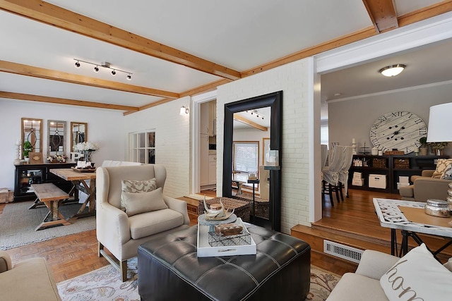 living area featuring beamed ceiling, visible vents, and crown molding