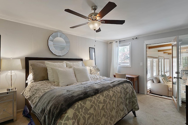 carpeted bedroom with ceiling fan and ornamental molding