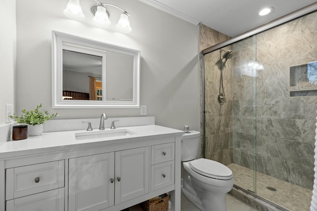 bathroom featuring toilet, a stall shower, vanity, and crown molding