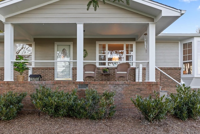 view of front of property with covered porch and brick siding