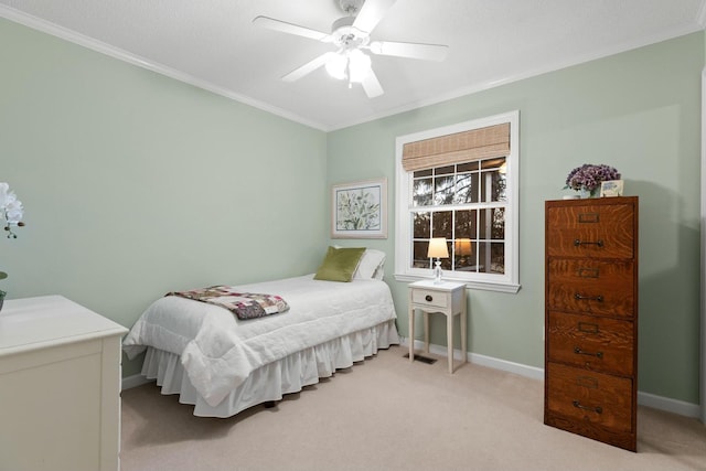 bedroom with a ceiling fan, carpet, crown molding, and baseboards