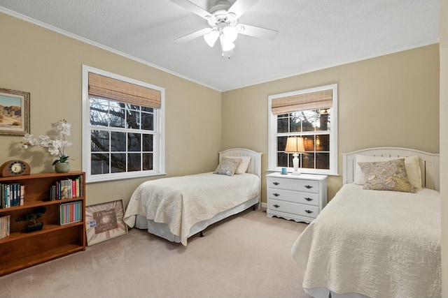 bedroom featuring multiple windows, ornamental molding, a ceiling fan, and light colored carpet