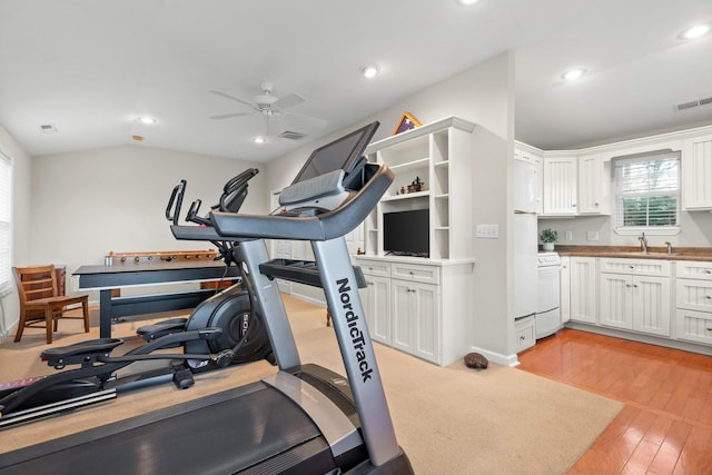 workout room with recessed lighting, visible vents, a sink, and light wood finished floors