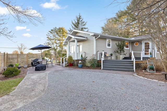 view of front of house featuring a patio area and fence