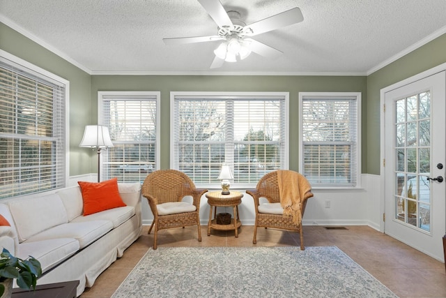 sunroom featuring a ceiling fan