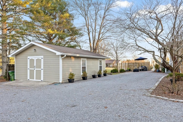 exterior space featuring an outbuilding and fence