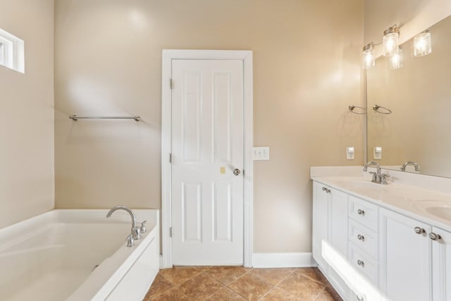 bathroom featuring a garden tub, a sink, baseboards, tile patterned floors, and double vanity