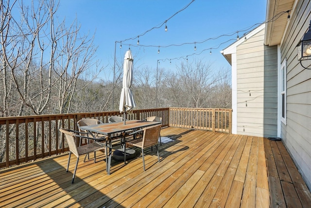 wooden terrace featuring outdoor dining area