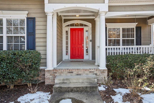 entrance to property featuring a porch