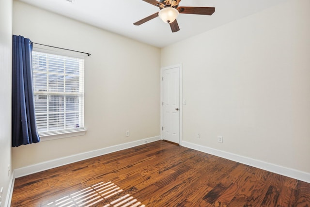 empty room featuring a ceiling fan, baseboards, and wood finished floors