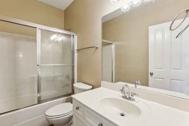 full bathroom featuring enclosed tub / shower combo, vanity, and toilet