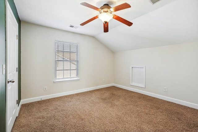 additional living space with lofted ceiling, ceiling fan, carpet floors, visible vents, and baseboards