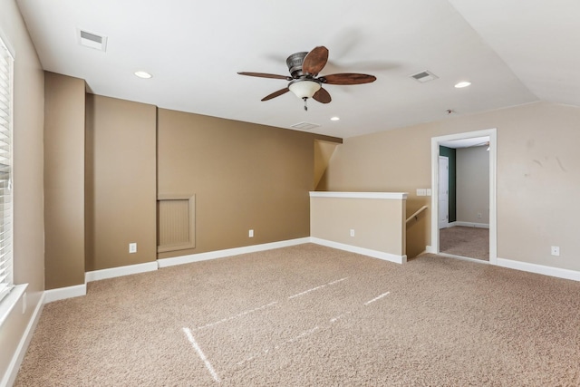 empty room with baseboards, light colored carpet, visible vents, and recessed lighting