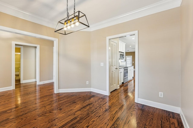 unfurnished dining area featuring dark wood-type flooring, a notable chandelier, crown molding, and baseboards