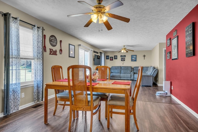 dining space featuring plenty of natural light, visible vents, and wood finished floors