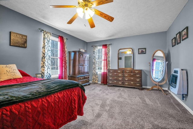 bedroom with baseboards, carpet flooring, a textured ceiling, and heating unit