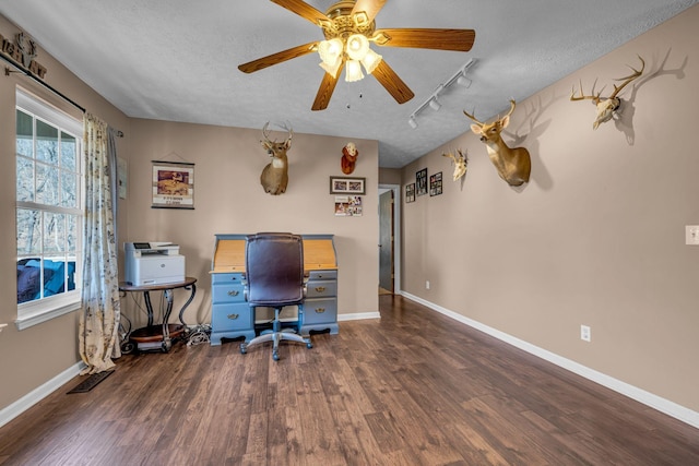 office area with dark wood-style floors, a textured ceiling, and baseboards