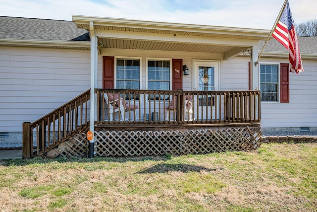 view of front of house featuring a front yard, crawl space, covered porch, and roof with shingles