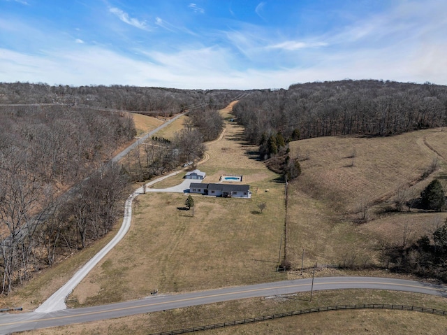 birds eye view of property with a view of trees