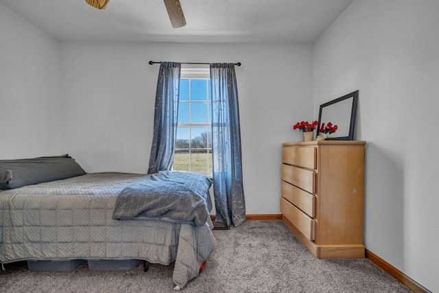 bedroom featuring ceiling fan, light colored carpet, and baseboards