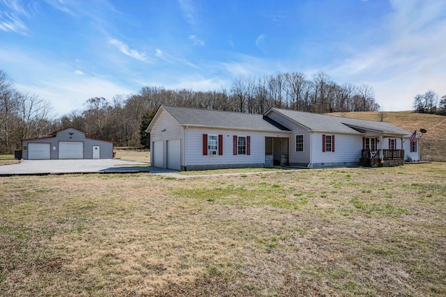 ranch-style house featuring a garage, crawl space, a front lawn, and an outbuilding