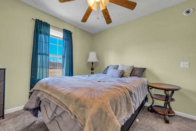 carpeted bedroom with ceiling fan and baseboards