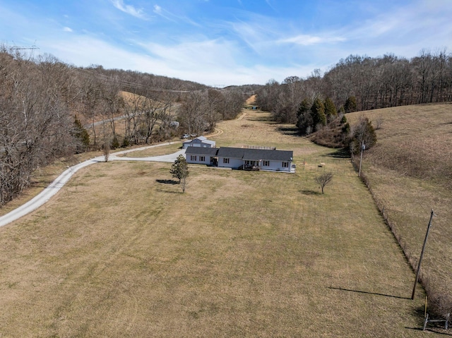 birds eye view of property with a forest view and a rural view